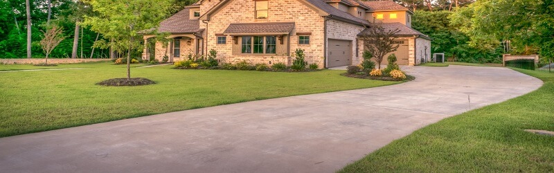 Image of a sealed concrete Driveway leading to a house