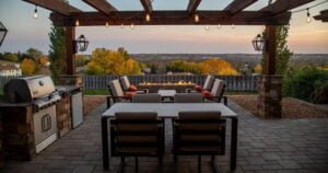 Image of a stamped concrete patio with barbecue, tables, chairs, and a pergola