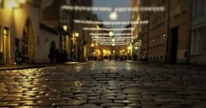 Image of a street at night with a cobblestone floor