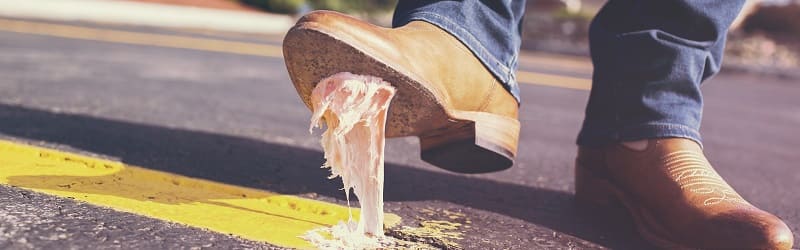 Brown shoes stepping on a chewing gum